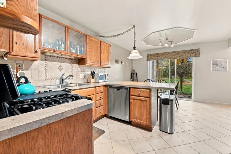 Kitchen with gas range and door to the yard