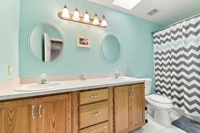 Full bath with double vanity and skylight